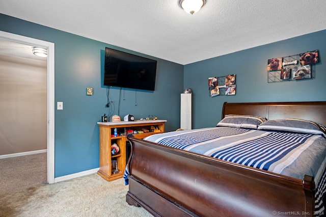 carpeted bedroom featuring a textured ceiling