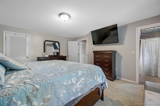 bedroom with light carpet and a textured ceiling