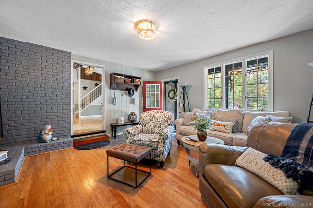 living room with light hardwood / wood-style flooring and a textured ceiling