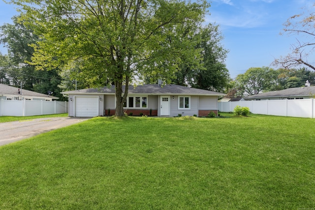 view of front of home with a garage and a front lawn