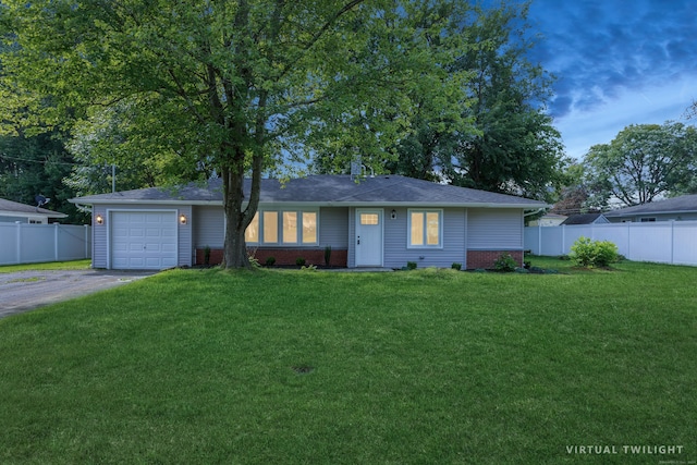 ranch-style home featuring a front yard and a garage