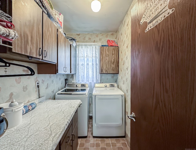 washroom with light tile patterned floors, independent washer and dryer, and cabinets