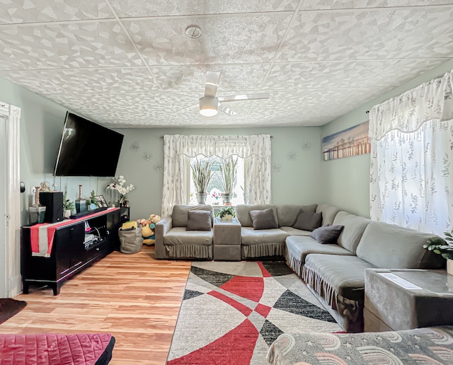 living room featuring ceiling fan and light hardwood / wood-style floors