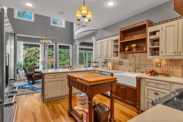 kitchen featuring pendant lighting, an inviting chandelier, sink, and a healthy amount of sunlight