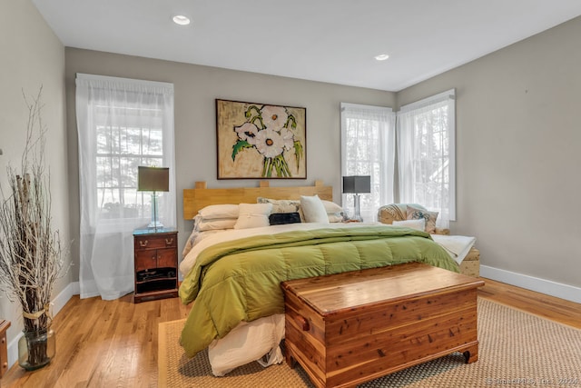 bedroom featuring light hardwood / wood-style floors and multiple windows