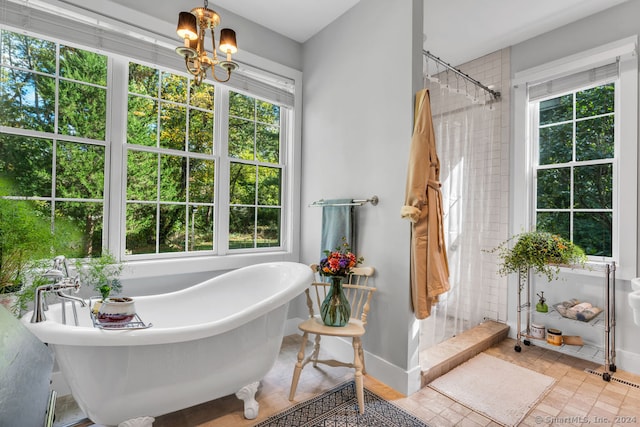 bathroom featuring tile patterned flooring, a notable chandelier, and independent shower and bath