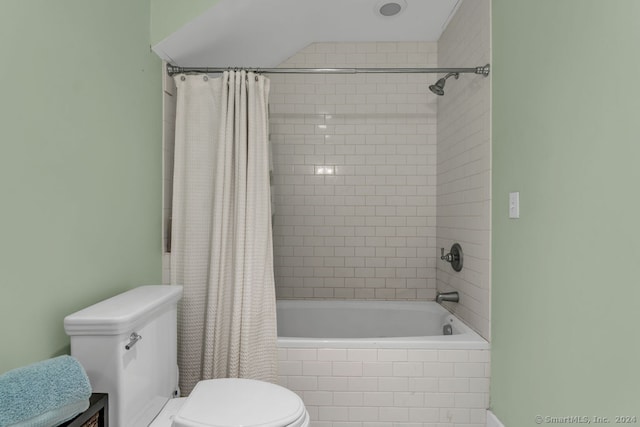 bathroom with shower / tub combo with curtain and toilet