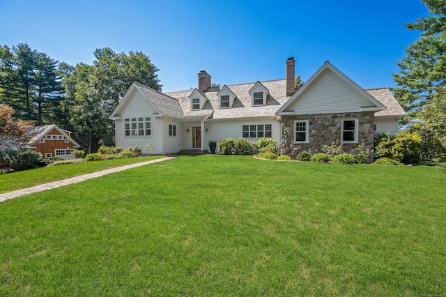 cape cod home with a front lawn