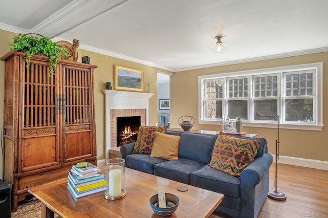 living room featuring a brick fireplace, crown molding, light hardwood / wood-style floors, and a healthy amount of sunlight