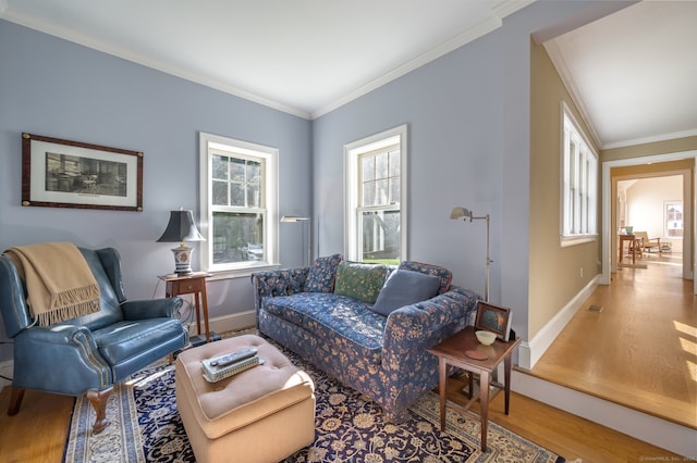 living room featuring crown molding, hardwood / wood-style floors, and plenty of natural light