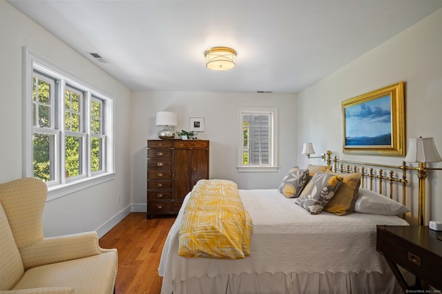 bedroom with hardwood / wood-style floors