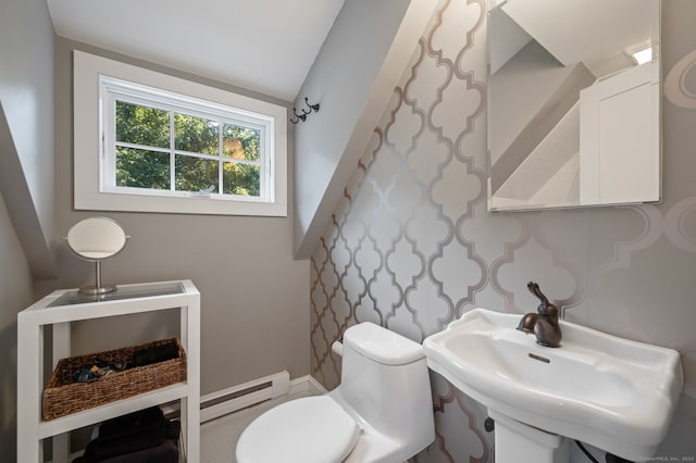 bathroom featuring lofted ceiling, toilet, sink, and a baseboard radiator