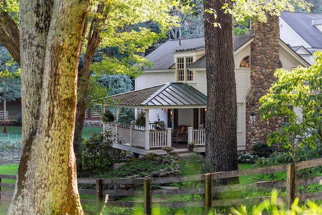 rear view of property with covered porch