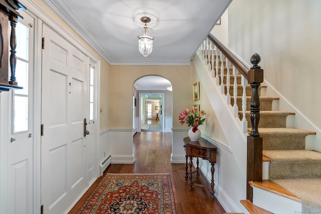 entryway with plenty of natural light, dark hardwood / wood-style floors, a baseboard radiator, and ornamental molding