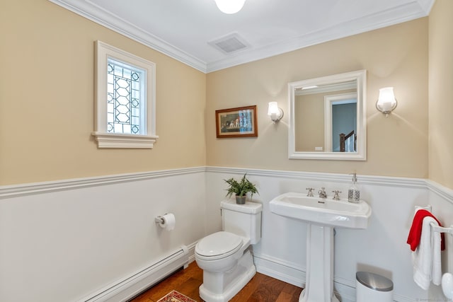 bathroom with a baseboard radiator, toilet, hardwood / wood-style flooring, and ornamental molding