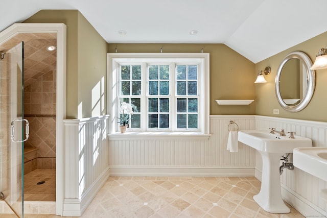 bathroom with lofted ceiling and a shower with shower door