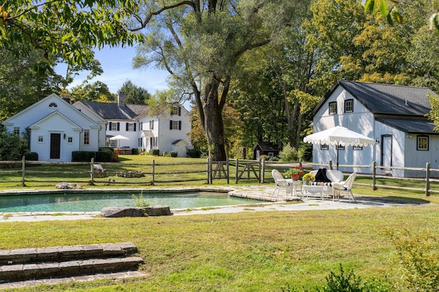 view of yard with a patio, a water view, and fence