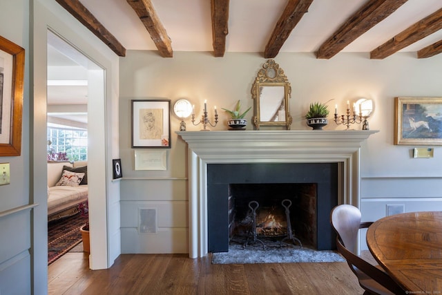 44 S St, Roxbury, CT 06783 - details with beamed ceiling, a warm lit fireplace, and wood finished floors