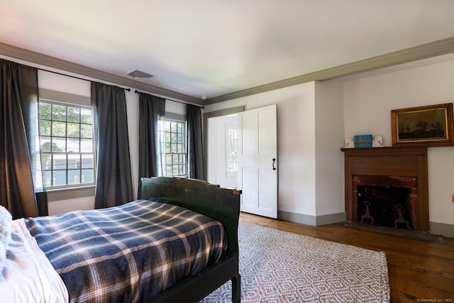 44 S St, Roxbury, CT 06783 - bedroom with visible vents, a fireplace with flush hearth, wood finished floors, and multiple windows