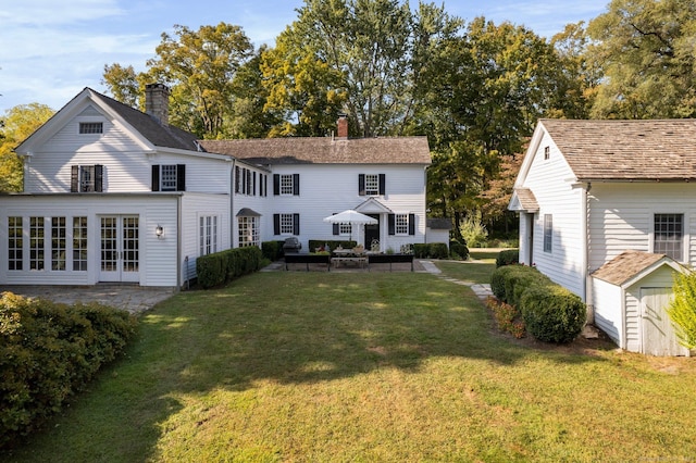 44 S St, Roxbury, CT 06783 - back of property featuring a patio, a lawn, a shed, and a chimney
