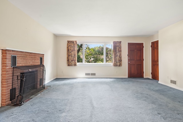 unfurnished living room with a brick fireplace and carpet flooring