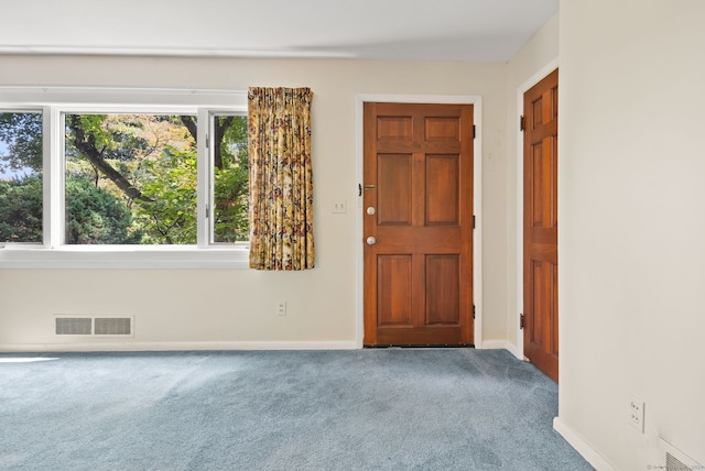 view of carpeted foyer entrance