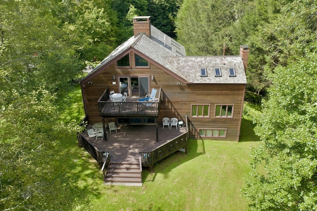 148 Flanders Rd, Woodbury, CT 06798 - back of property featuring a wooden deck, a lawn, a chimney, and a wooded view