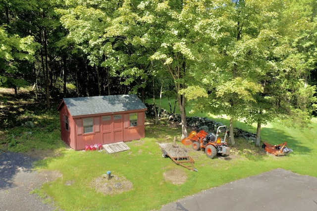 exterior space featuring an outbuilding, driveway, and a storage unit