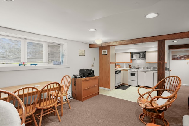 kitchen with white cabinets, sink, white appliances, and light carpet