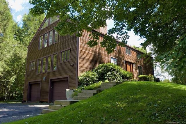 view of property with a garage and driveway