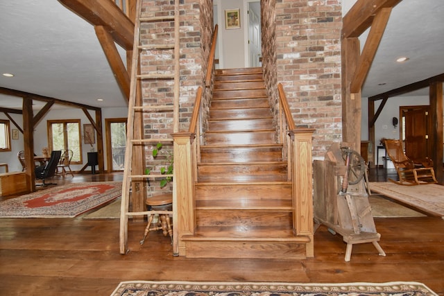 stairs featuring hardwood / wood-style floors