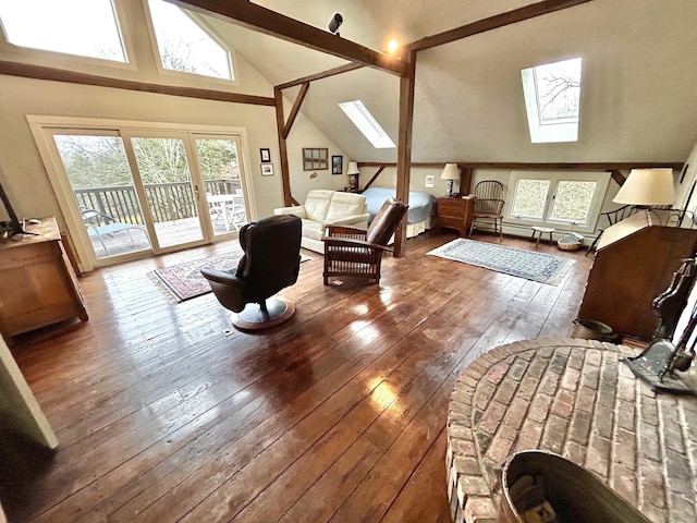 living room with hardwood / wood-style floors and lofted ceiling with skylight