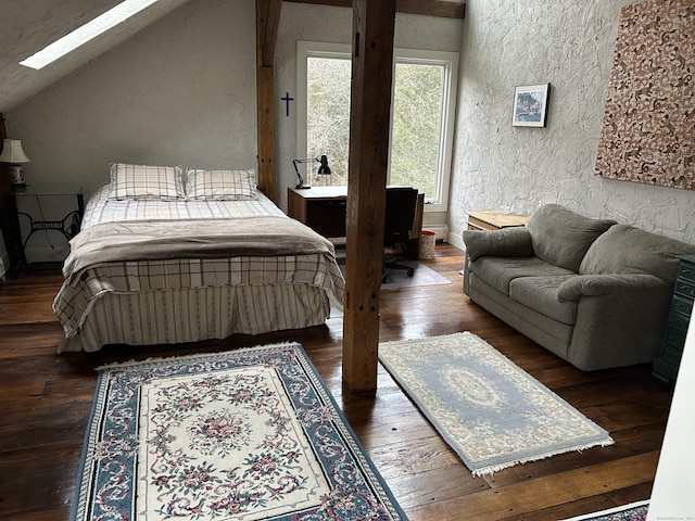 bedroom with hardwood / wood-style floors and vaulted ceiling with skylight