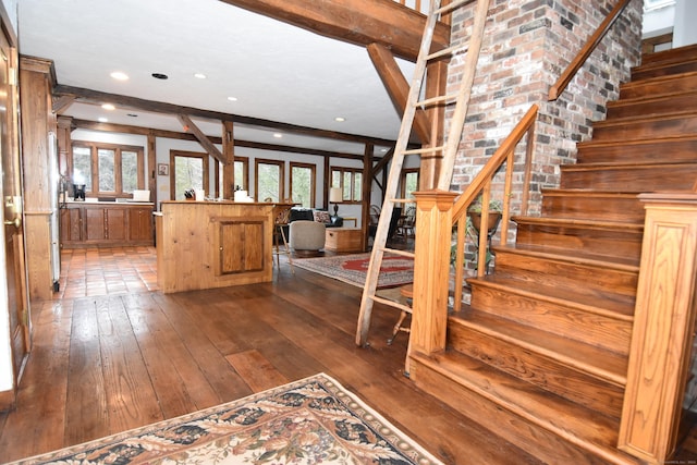 entrance foyer with a healthy amount of sunlight, stairway, and beamed ceiling