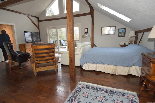 bedroom with dark hardwood / wood-style floors, lofted ceiling with skylight, and a textured ceiling