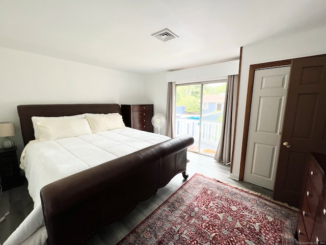 bedroom with light wood-type flooring and access to outside