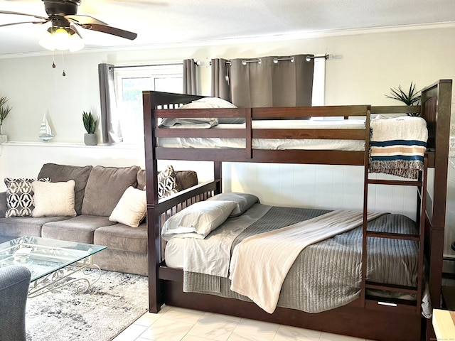 bedroom with ceiling fan and crown molding