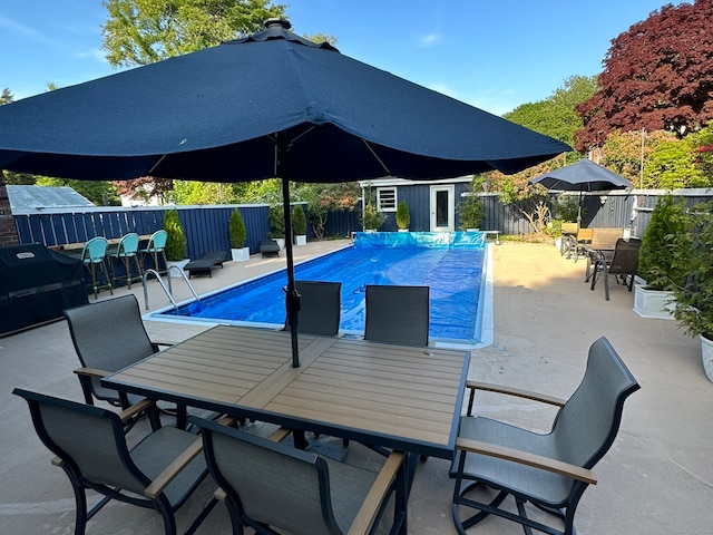 view of pool featuring a patio and an outbuilding