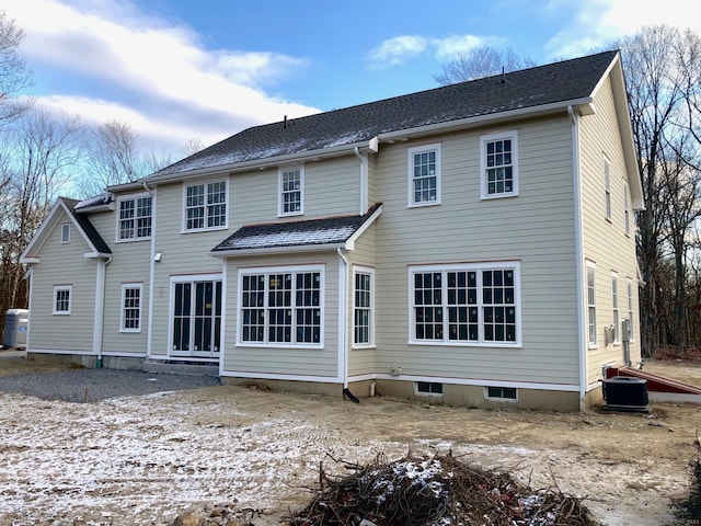 rear view of property featuring central AC