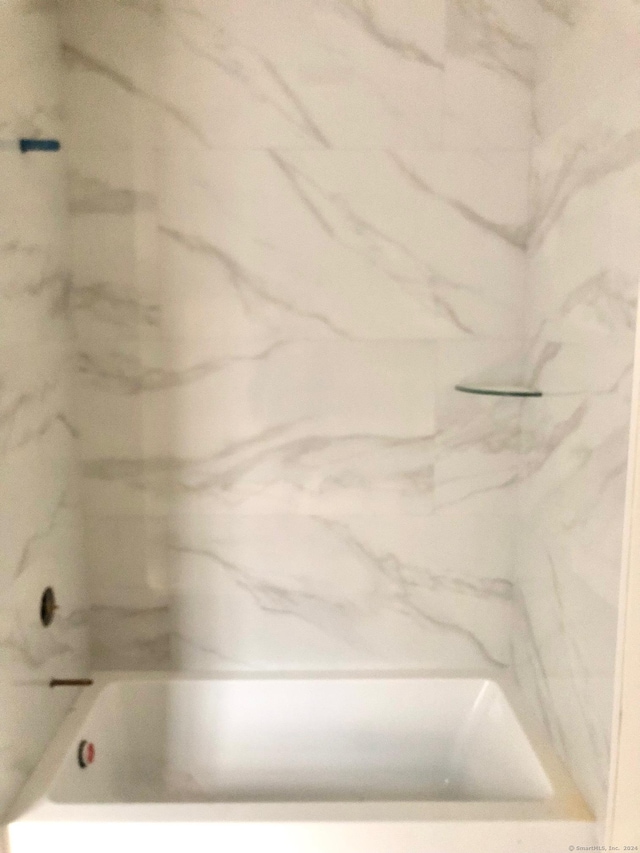 bathroom featuring a tub to relax in