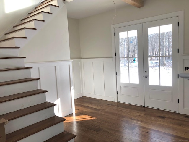 entryway featuring beam ceiling, dark hardwood / wood-style flooring, and french doors