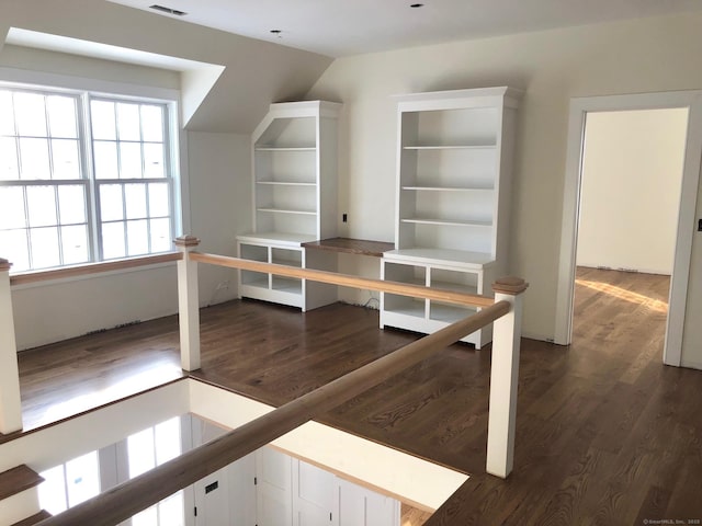 unfurnished office featuring dark hardwood / wood-style floors and vaulted ceiling