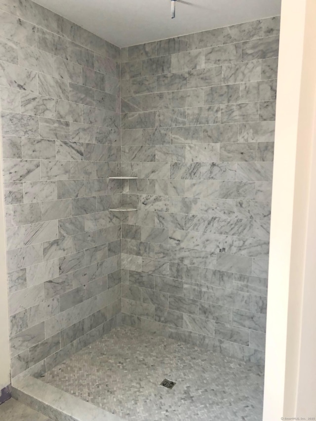 bathroom with a tile shower