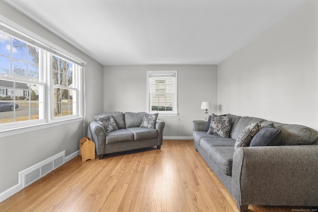 living room with light hardwood / wood-style flooring and plenty of natural light