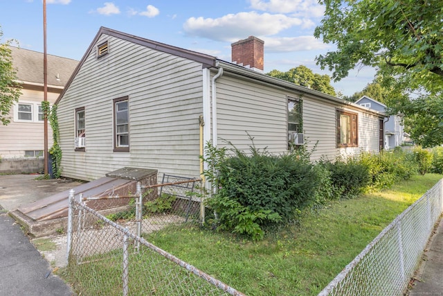 view of side of property with a lawn