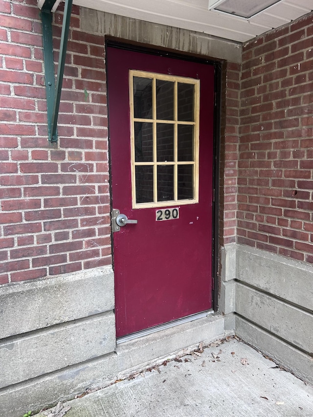 property entrance with brick siding