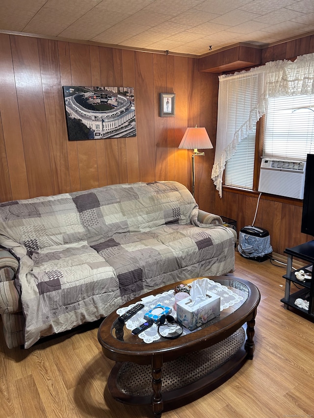 living room with light wood-type flooring and wooden walls