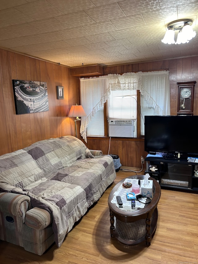 living room with cooling unit, wood walls, and wood-type flooring