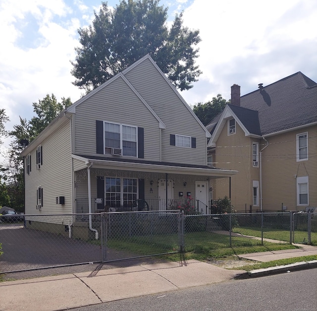 view of front facade with a fenced front yard, covered porch, and a gate