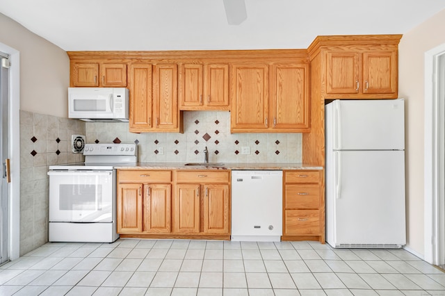 kitchen with light tile patterned flooring, white appliances, and sink